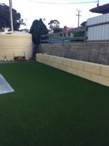 After Shot - Artificial Turf Limestone Brick Retaining Wall